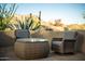 Cozy patio seating area features comfortable wicker furniture and a view of the natural desert landscape at 10040 E Happy Valley Rd # 2022, Scottsdale, AZ 85255