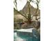Beautiful pool with water feature surrounded by desert landscaping at 10040 E Happy Valley Rd # 2022, Scottsdale, AZ 85255