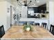 Cozy dining area adjacent to the kitchen, featuring a stylish table set and sleek black bar stools at 1005 W 19Th Ave, Apache Junction, AZ 85120