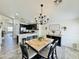 Open dining and kitchen area featuring a stylish chandelier and modern black and white decor at 1005 W 19Th Ave, Apache Junction, AZ 85120