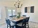 Inviting dining area with an elegant chandelier, wood table, and french doors to the backyard at 1005 W 19Th Ave, Apache Junction, AZ 85120