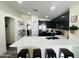 Modern kitchen with sleek black cabinetry, stainless steel appliances, and a spacious quartz countertop island at 1005 W 19Th Ave, Apache Junction, AZ 85120