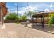 Backyard with stylish pavers, gazebo, outdoor fireplace, and mature trees at 1123 E Buckingham Ave, Gilbert, AZ 85297