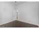 Bedroom with wood-look floors and a door leading to the hall at 1123 E Buckingham Ave, Gilbert, AZ 85297