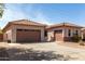 Spacious home exterior featuring a tile roof, desert landscaping, and a circular driveway at 1123 E Buckingham Ave, Gilbert, AZ 85297