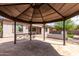 View from inside gazebo of home's exterior, fireplace, and synthetic lawn at 1123 E Buckingham Ave, Gilbert, AZ 85297