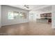 Open concept living area with tile flooring, large windows, and a view into the kitchen at 1123 E Buckingham Ave, Gilbert, AZ 85297