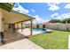 Backyard showcasing the pool, patio, green lawn, and covered outdoor living space at 1237 E Gemini Dr, Tempe, AZ 85283