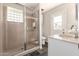 Bathroom with glass shower, vanity, and access to backyard at 1237 E Gemini Dr, Tempe, AZ 85283