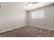 This bedroom features carpet flooring, a ceiling fan, and a window at 1237 E Gemini Dr, Tempe, AZ 85283