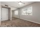 This bedroom features carpet flooring, a ceiling fan, and a window at 1237 E Gemini Dr, Tempe, AZ 85283