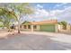 Inviting one-story home featuring desert landscaping and a spacious driveway leading to the attached garage at 1237 E Gemini Dr, Tempe, AZ 85283