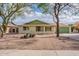 Charming single-story home with desert landscaping, a green roof, and a matching garage door at 1237 E Gemini Dr, Tempe, AZ 85283