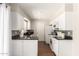 Stylish kitchen featuring white cabinets, mosaic backsplash, and modern appliances at 1237 E Gemini Dr, Tempe, AZ 85283