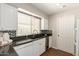 Well-lit kitchen showcasing granite countertops, stainless steel appliances, and white cabinetry at 1237 E Gemini Dr, Tempe, AZ 85283