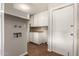 This laundry room features white cabinets, wood-look flooring, and a utility sink at 1237 E Gemini Dr, Tempe, AZ 85283