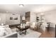 Open-concept living room with wood floors, stylish furniture, and a dining area at 1237 E Gemini Dr, Tempe, AZ 85283