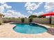 Backyard oasis featuring a kidney-shaped pool with a waterfall feature and hot tub at 1237 E Gemini Dr, Tempe, AZ 85283