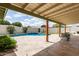 Inviting backyard pool with a tiled patio, waterfall feature, and covered outdoor seating at 1237 E Gemini Dr, Tempe, AZ 85283
