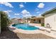 Sparkling pool surrounded by beautiful landscaping, a diving board, and covered patio at 1237 E Gemini Dr, Tempe, AZ 85283