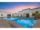 Luxury backyard with a pool, spa, and modern architectural design, creating an oasis for relaxation and entertainment at 12620 N 70Th St, Scottsdale, AZ 85254