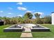 Backyard fire pit surrounded by manicured landscaping and gravel offers a cozy outdoor space to relax and entertain at 12620 N 70Th St, Scottsdale, AZ 85254
