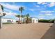 Desert landscaping, palm trees, blue sky, and modern white building at 12620 N 70Th St, Scottsdale, AZ 85254
