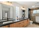 Modern bathroom with double sinks, a glass enclosed shower, and stylish light fixtures, offering a spa-like experience at 12620 N 70Th St, Scottsdale, AZ 85254