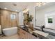 Modern bathroom featuring dual sinks with granite countertops, soaking tub, and stylish wood-look tile at 12620 N 70Th St, Scottsdale, AZ 85254