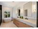 Elegant bathroom featuring dual sinks, soaking tub, marble countertops, and black-tiled accents at 12620 N 70Th St, Scottsdale, AZ 85254