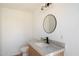 Modern bathroom with new fixtures, a stone countertop, a vanity, and round mirror at 12620 N 70Th St, Scottsdale, AZ 85254