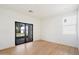 Bright bedroom featuring wood floors, neutral paint and glass patio doors that bring in the light and view at 12620 N 70Th St, Scottsdale, AZ 85254