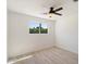 Bright bedroom featuring a ceiling fan and a window overlooking a green landscape, creating a serene atmosphere at 12620 N 70Th St, Scottsdale, AZ 85254