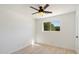 Bright bedroom features a ceiling fan and a window looking out on lush green foliage at 12620 N 70Th St, Scottsdale, AZ 85254