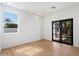 Bright bedroom featuring wood floors, neutral paint and glass patio doors that bring in the light and view at 12620 N 70Th St, Scottsdale, AZ 85254