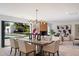 Elegant dining room with a modern chandelier and an open view to the pool and backyard at 12620 N 70Th St, Scottsdale, AZ 85254