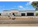 The home's modern design is beautifully displayed with a two-car garage and desert landscaping on a sunny day at 12620 N 70Th St, Scottsdale, AZ 85254