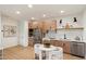Well-lit kitchen with modern cabinetry, stainless steel appliances, and an open dining area, perfect for culinary enthusiasts at 12620 N 70Th St, Scottsdale, AZ 85254