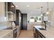 Updated kitchen showcasing modern appliances, quartz countertops, stylish cabinetry and a view through the window at 12620 N 70Th St, Scottsdale, AZ 85254