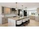 This kitchen features an island with seating, quartz countertops, pendant lights, and stainless steel appliances at 12620 N 70Th St, Scottsdale, AZ 85254