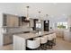 This updated kitchen features a large island with seating, quartz countertops, and stylish pendant lighting at 12620 N 70Th St, Scottsdale, AZ 85254