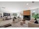 Open-concept living room features a fireplace, comfortable seating, and seamlessly integrates the dining and bar area at 12620 N 70Th St, Scottsdale, AZ 85254