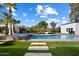 Backyard pool, jacuzzi, grassy area, and lush landscaping create a backyard oasis perfect for relaxation at 12620 N 70Th St, Scottsdale, AZ 85254