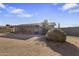 View of the backyard featuring landscaping, block wall, and enclosed patio at 1459 S Mara Dr, Apache Junction, AZ 85120