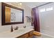 Well-lit bathroom with a dark framed mirror, vanity, and shower-tub combo at 1459 S Mara Dr, Apache Junction, AZ 85120