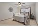 Bedroom with ceiling fan, carpeted floors, iron bed frame, and natural light at 1459 S Mara Dr, Apache Junction, AZ 85120