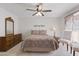 A cozy bedroom featuring a ceiling fan, neutral decor, and lots of natural light at 1459 S Mara Dr, Apache Junction, AZ 85120