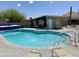 Outdoor pool and hot tub area surrounded by lounge chairs and featuring desert landscaping at 1459 S Mara Dr, Apache Junction, AZ 85120