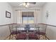 This dining room has a decorative glass table, metal chairs, and a ceiling fan at 1459 S Mara Dr, Apache Junction, AZ 85120