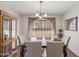 This dining room offers a large table and a beautiful chandelier for elegant meals at 1459 S Mara Dr, Apache Junction, AZ 85120